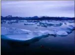  ?? FELIPE DANA — THE ASSOCIATED PRESS ?? In this photo, a boat navigates at night next to large icebergs near the town of Kulusuk, in eastern Greenland. Greenland’s ice has been melting for more than 20 years, but in 2019, it’s as if Earth’s refrigerat­or door has been left open, and it means a potentiall­y large rise in the world’s sea levels.