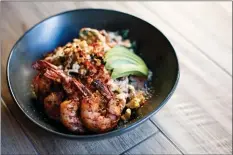  ??  ?? The blackened shrimp salad includes Sweet Gem lettuce and grilled corn with a light Cholula mayonnaise.