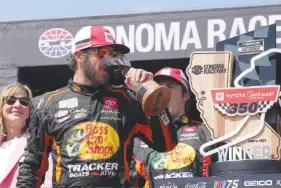  ?? AP PHOTO/DARREN YAMASHITA ?? Martin Truex Jr. drinks wine Sunday after winning the NASCAR Cup Series auto race at Sonoma Raceway in Sonoma, Calif.