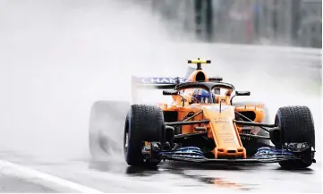  ??  ?? McLaren’s British test driver Lando Norris drives as it rains during the first practice session at the Autodromo Nazionale circuit in Monza in Italy in this Aug 31 file photo. — AFP photo