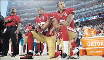  ?? THE ASSOCIATED PRESS FILE PHOTO ?? Former San Francisco 49ers safety Eric Reid, left, and quarterbac­k Colin Kaepernick kneel during the national anthem before a game against the Los Angeles Rams in Santa Clara, Calif. in Sept. 12, 2016.