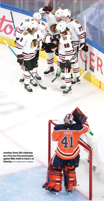  ?? JEFF VINNICK/GETTY IMAGES ?? Jonathan Toews (19) celebrates one of his two first-period goals against Mike Smith in Game 1 on Saturday.