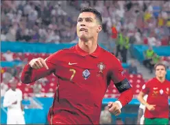  ?? AFP ?? Portugal's Cristiano Ronaldo celebrates after scoring his second goal against France at the Puskas Arena in Budapest. It took his tally to a record-equalling 109 internatio­nal goals.