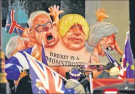 ?? REUTERS ?? A caricature of Britain's Prime Minister Theresa May (right) Boris Johnson (centre) and Michael Gove is paraded by anti-brexit protesters in London.