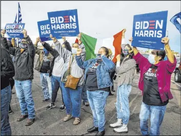  ??  ?? Attendees gather and sing before a car parade Saturday on the Strip to celebrate Joe Biden’s victory over President Donald Trump.