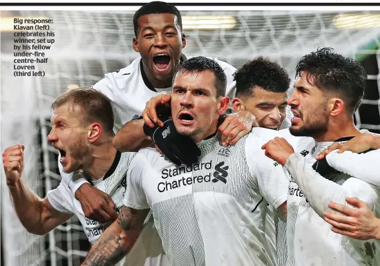  ??  ?? Big response: Klavan (left) celebrates his winner, set up by his fellow under-fire centre-half Lovren (third left)