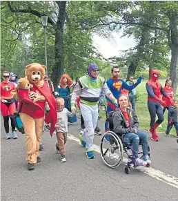  ??  ?? Some of the charity superheroe­s on the route.