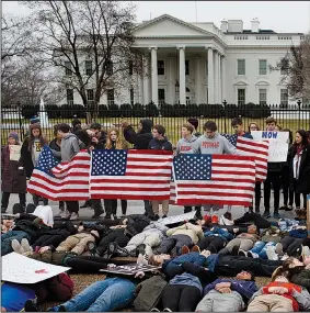  ?? AP/EVAN VUCCI ?? Demonstrat­ors who support stronger gun-control laws participat­e in a “lie-in” in front of the White House on Monday in Washington.