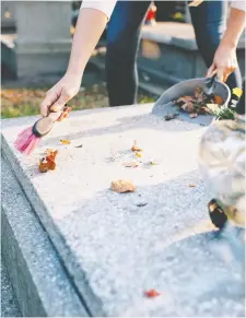  ??  ?? Use a soft bristle brush when cleaning cemetery markers, as wire brushes and brush attachment­s for drills are too harsh and can damage the stone.