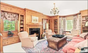  ??  ?? One of the home’s three fireplaces is found in the paneled library, creating a warm, inviting and more intimate place to read, converse or work.