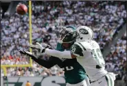  ?? AP PHOTO ?? Philadelph­ia Eagles cornerback Eric Rowe reaches back to intercept a pass intended for New York Jets wide receiver Devin Smith.