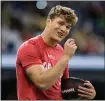  ?? CHARLIE REIDEL — AP PHOTO ?? Michigan quarterbac­k J.J. McCarthy talks to a fellow player during the scouting combine, March 2, in Indianapol­is.