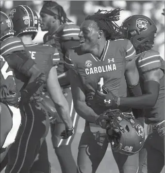  ?? SEAN RAYFORD/AP ?? South Carolina defensive back Jaycee Horn (1) celebrates with teammates Saturday after a win over Auburn.