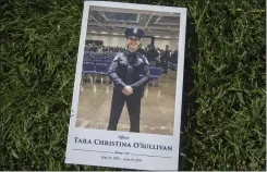  ??  ?? The program for the funeral service of O’Sullivan rests on the grass outside Bayside Adventure Church.