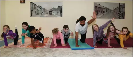  ??  ?? Children doing the ‘Tiger Pose’ with Yoga Teacher Simon Pachikara at the Boherbue Traditiona­l Indian Yoga Centre.