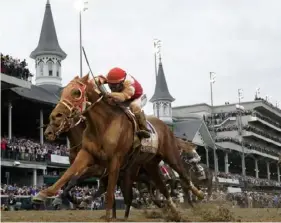  ?? Jeff Roberson/AP ?? Rich Strike, with Sonny Leon aboard, crosses the finish line to win the 148th running of the Kentucky Derby horse race at Churchill Downs on, May 7 in Louisville, Ky.