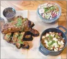  ??  ?? Baby back pork ribs are served with baked beans, queso and coleslaw.