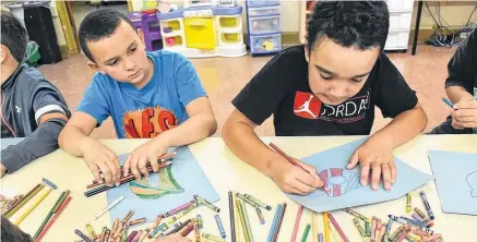  ?? Tina Comeau ?? Kolh Archambaul­t and Mason Johnson work on their Central Care Club project at Yarmouth Central Elementary School.