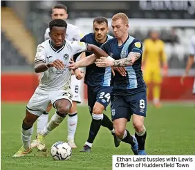  ?? ?? Ethan Laird tussles with Lewis O’Brien of Huddersfie­ld Town