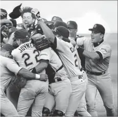  ?? Patrick Downs Los Angeles Times ?? obbed by his Padres teammates after their 11-inning, 2-0 win that coman Diego the 1996 NL West title. The Dodgers settled for the wild card.