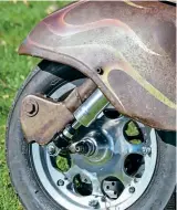  ??  ?? Enough stopping power from the outboard disc hidden underneath the turning front mudguard.