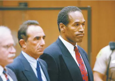  ?? AP pool file photo ?? O.J. Simpson stands as he listens to Municipal Judge Kathleen Kennedy-Powell as she reads her decision to hold him over for trial on July 8, 1994, in connection with the June 12 slayings of his ex-wife Nicole Brown Simpson and Ronald Goldman. Simpson, the decorated football superstar and Hollywood actor who was acquitted of charges he killed his former wife and her friend but later found liable in a separate civil trial, has died. He was 76.