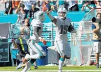  ?? JOE CAVARETTA/SUN SENTINEL ?? Dolphins receiver Albert Wilson, right, celebrates with Jakeem Grant as he breaks free for a touchdown against the Raiders last season.