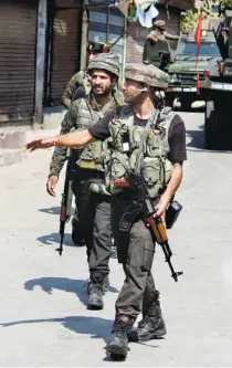  ??  ?? SECURITY PERSONNEL during a cordon-and-search operation near an encounter site in Sopore, Srinagar, in October 2018.