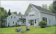  ??  ?? Its cladding of grey clapboard with pale yellow trim are the same colours and style as the original 1840s house.