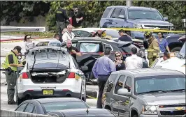  ?? LANNIS WATERS / THE PALM BEACH POST ?? Authoritie­s surround the black SUV on Wednesday that had been driven by Hugo Selva, after a Palm Beach County sheriff’s deputy fatally shot him after a series of wrecks on Interstate 95 near the Lantana exit.