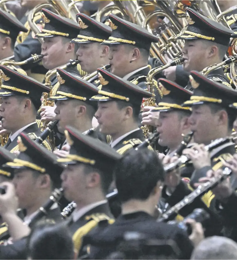  ?? PICTURE: WANG ZHAO/AFP VIA GETTY IMAGES ?? Members of the People’s Liberation Army’s band rehearse ahead of the closing ceremony of the 14th National People’s Congress at the Great Hall of the People in Beijing. With 2,977 members in 2023, it is the largest legislativ­e body in the world. The NPC is elected for a term of five years. It holds annual sessions every spring, usually lasting from 10 to 14 days