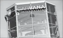  ?? Kristoffer Tripplaar Sipa USA ?? CARVANA, which lets drivers shop online and then pick up their car from a glass structure without so much as a test drive, forged the path Shift hopes to follow.