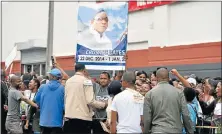  ?? Picture: EUGENE COETZEE ?? PASTOR’S PEOPLE: Followers of Pastor Timothy Omotoso, who is facing charges for alleged human traffickin­g, hold his picture as they gather outside the Port Elizabeth Magistrate’s Court