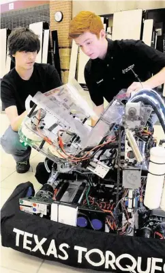  ?? David Hopper ?? Texan Torque team members Robert Oakley, left, and Conner Smith worked on the team’s machine during a robotics tournament that was hosted for Vogel Elementary School students in May.