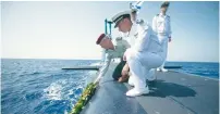  ?? (IDF) ?? THEN-IDF CHIEF of staff Benny Gantz (left) and then-Israel Navy commander Ram Rothberg (foreground) are seen on the ‘INS Tanin’ Dolphin 2-class submarine on September 21, 2014, after it arrived from its shipyard in Germany.