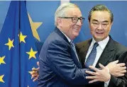  ?? [AP PHOTO] ?? European Commission President Jean-Claude Juncker, left, prepares to shake hands with China’s Foreign Minister Wang Yi before a meeting Friday at EU headquarte­rs in Brussels. The European Union and China say they will deepen ties on trade and investment and that they fully support global trade rules, after U.S. President Donald slapped tariffs on steel and aluminum imports.