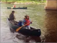  ?? JO BROOKS VIA AP ?? In this June 4 photo, paddlers Lisa Dahill and Mark Kutolowski in the front canoe and Steve Blackmer in the back paddle make their way to a campsite along the Connecticu­t River in North Stratford, N.H. Episcopal dioceses in New England have organized a...