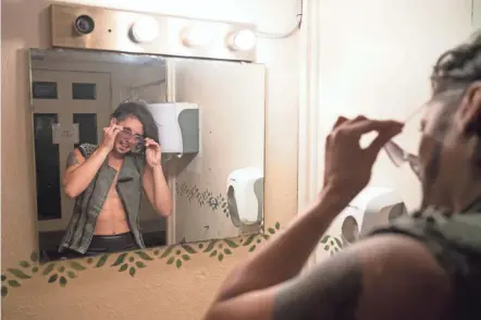  ?? PHOTOS BY JOSHUA A. BICKEL/COLUMBUS DISPATCH ?? Now starting to get into character, Jess Bowen gives herself one last look in the mirror on Aug. 21 in Chillicoth­e.