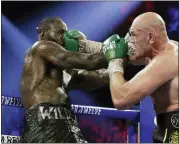 ?? ISAAC BREKKEN — THE ASSOCIATED PRESS ?? Tyson Fury, of England, lands a right to Deontay Wilder during a WBC heavyweigh­t championsh­ip boxing match Saturday, Feb. 22, 2020, in Las Vegas.