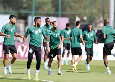  ?? — AFP ?? Saudi Arabia’s midfielder Abdullah Otayf (C) and teammates take part in a training session at the Sealine Training Site in Sealine, south of Doha.