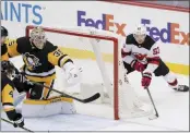  ?? KEITH SRAKOCIC - THE ASSOCIATED PRESS ?? New Jersey Devils’ Jesper Bratt (63) brings the puck around the net behind Pittsburgh Penguins goaltender Tristan Jarry (35) to score the game winning goal during overtime of an NHL hockey game, Sunday, March 21, 2021, in Pittsburgh. The Devils won 2-1.