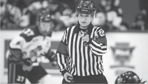  ?? JEFF MCINTOSH / THE CANADIAN PRESS FILES ?? Erica Holmes officiates a game at the Mac’s midget tournament in Calgary. Holmes said she was being held back from working AJHL games.