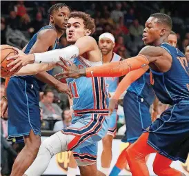  ?? [AP PHOTO] ?? Atlanta Hawks guard Trae Young, left, drives to the basket past Oklahoma City’s Dennis Schroder during the first half of Tuesday’s game at State Farm Arena in Atlanta.