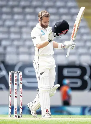  ?? PHOTO: GETTY IMAGES ?? Captain’s knock . . . A typically understate­d Kane Williamson acknowledg­es making his 18th test century on day two of the first test between New Zealand and England at Eden Park in Auckland yesterday.