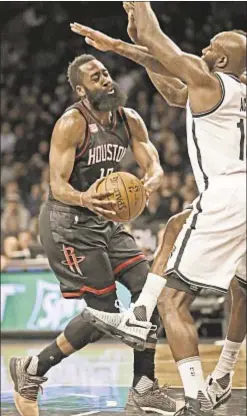  ??  ?? James Harden drives to hoop during triple-double performanc­e vs. Nets.