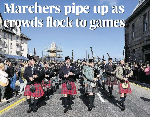  ??  ?? MIGHTY MARCH: The pipe band leads the parade down the street after they held aminute’s silence to remember the people who died in the Battle of Somme