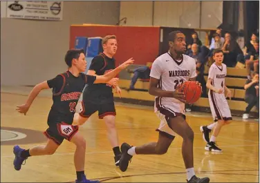  ?? Terrance Armstard/News-Times ?? Fast break: West Side Christian's Stephfan Tabe leads a fast break during the Warriors' contest against Garrett Memorial Christian during the 2018-19 season.