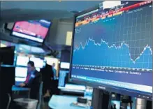  ?? Spencer Platt
Getty I mages ?? OVER TIME, accepting the risk that stock prices may fall pays off. Above, traders work at the New York Stock Exchange.