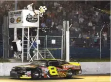  ??  ?? Thomson takes another checkered flag, this time at Delaware Speedway outside London, Ont., in an NASCAR Canadian Tire Series race in 2011.