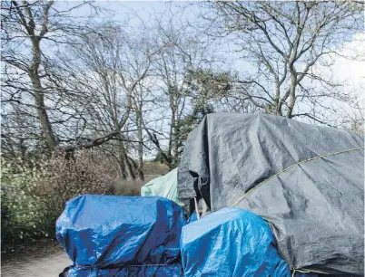  ??  ?? A homemade shelter at the entrance to Cuthbert Holmes Park. Homeless shelters are reducing beds and opening hours until the fall, increasing the number of people sleeping in drop-in shelters during the day.